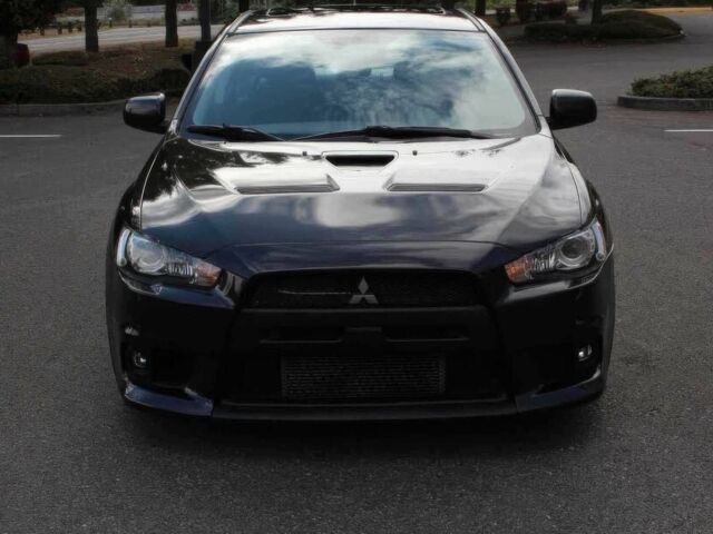 Черный Мицубиси Лансер Эволюшн, объемом двигателя 2 л и пробегом 88 тыс. км за 6400 $, фото 1 на Automoto.ua