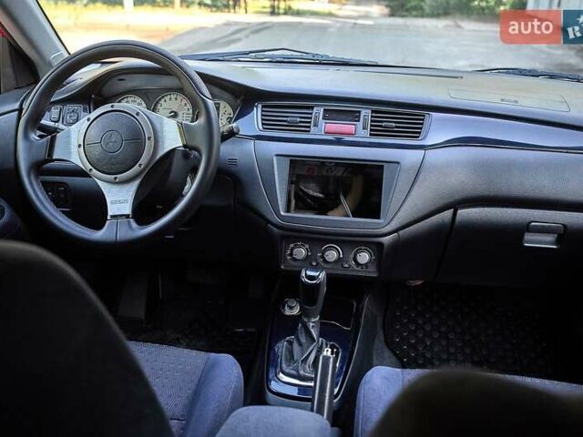 Красный Мицубиси Лансер Эволюшн, объемом двигателя 2 л и пробегом 148 тыс. км за 27000 $, фото 18 на Automoto.ua