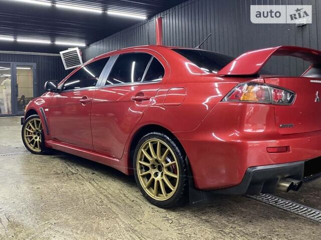 Красный Мицубиси Лансер Эволюшн, объемом двигателя 2 л и пробегом 56 тыс. км за 29000 $, фото 11 на Automoto.ua