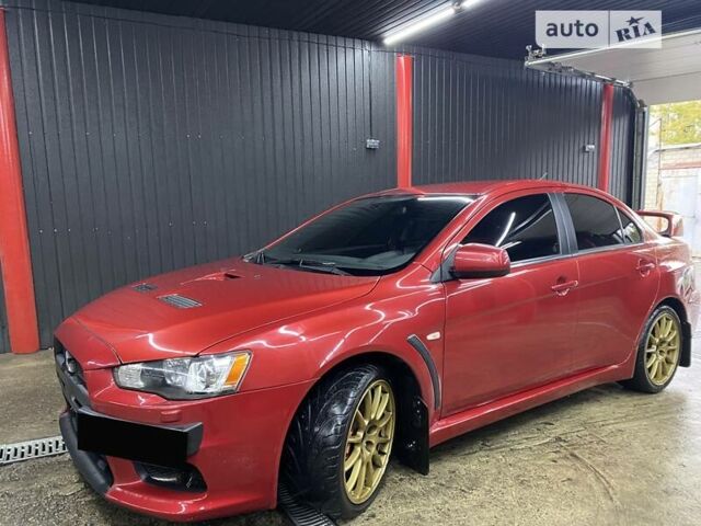 Красный Мицубиси Лансер Эволюшн, объемом двигателя 2 л и пробегом 56 тыс. км за 29000 $, фото 3 на Automoto.ua