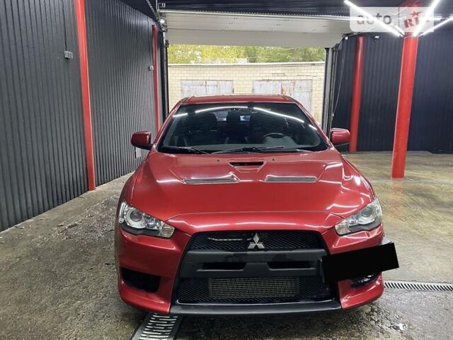 Красный Мицубиси Лансер Эволюшн, объемом двигателя 2 л и пробегом 56 тыс. км за 29000 $, фото 1 на Automoto.ua