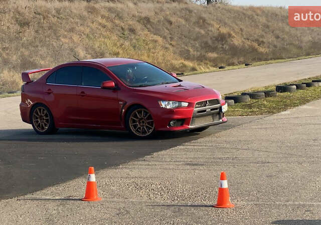 Красный Мицубиси Лансер Эволюшн, объемом двигателя 2 л и пробегом 115 тыс. км за 18000 $, фото 3 на Automoto.ua