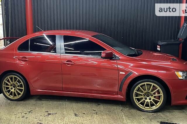 Красный Мицубиси Лансер Эволюшн, объемом двигателя 2 л и пробегом 56 тыс. км за 29000 $, фото 6 на Automoto.ua