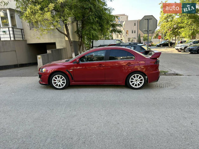 Красный Мицубиси Лансер Эволюшн, объемом двигателя 2 л и пробегом 115 тыс. км за 18000 $, фото 6 на Automoto.ua
