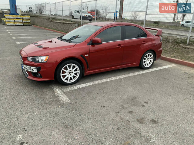 Красный Мицубиси Лансер Эволюшн, объемом двигателя 2 л и пробегом 115 тыс. км за 18000 $, фото 1 на Automoto.ua
