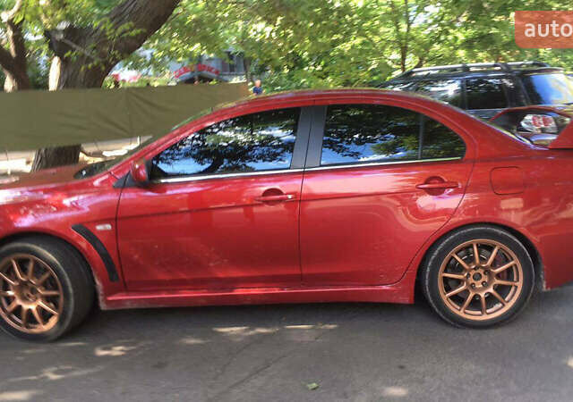 Красный Мицубиси Лансер Эволюшн, объемом двигателя 2 л и пробегом 115 тыс. км за 18000 $, фото 2 на Automoto.ua