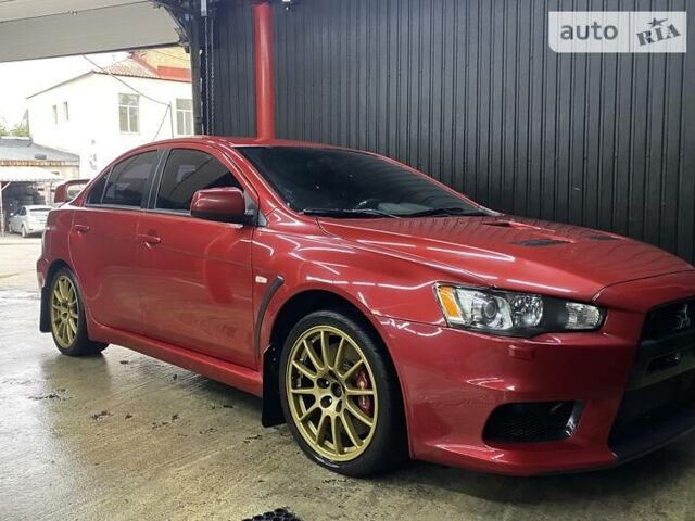 Красный Мицубиси Лансер Эволюшн, объемом двигателя 2 л и пробегом 56 тыс. км за 29000 $, фото 4 на Automoto.ua