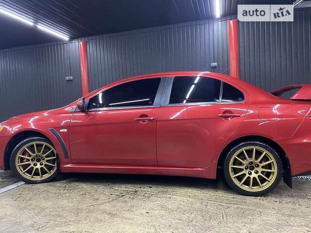 Красный Мицубиси Лансер Эволюшн, объемом двигателя 2 л и пробегом 56 тыс. км за 29000 $, фото 5 на Automoto.ua