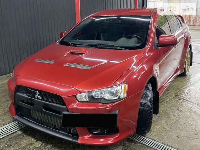 Красный Мицубиси Лансер Эволюшн, объемом двигателя 2 л и пробегом 56 тыс. км за 29000 $, фото 2 на Automoto.ua
