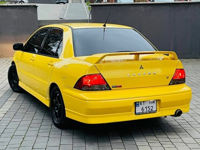Жовтий Міцубісі Лансер Еволюшн, об'ємом двигуна 2 л та пробігом 160 тис. км за 3999 $, фото 3 на Automoto.ua