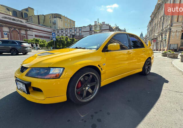 Жовтий Міцубісі Лансер Еволюшн, об'ємом двигуна 2 л та пробігом 124 тис. км за 32000 $, фото 1 на Automoto.ua