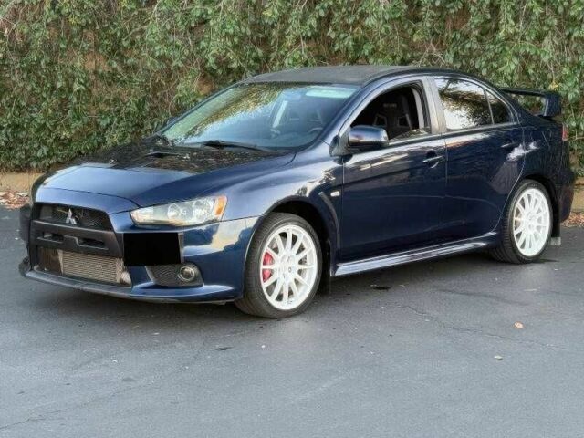 Синий Мицубиси Лансер Эволюшн, объемом двигателя 2 л и пробегом 144 тыс. км за 11000 $, фото 2 на Automoto.ua