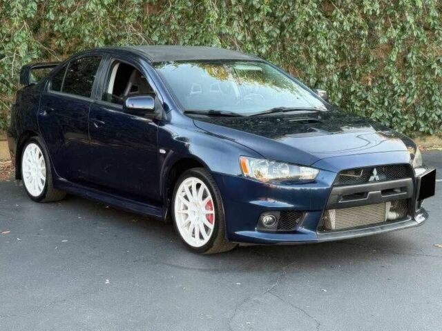 Синий Мицубиси Лансер Эволюшн, объемом двигателя 2 л и пробегом 144 тыс. км за 11000 $, фото 1 на Automoto.ua