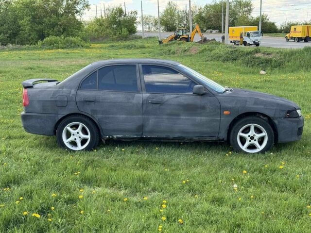 Чорний Міцубісі Lancer, об'ємом двигуна 0.18 л та пробігом 246 тис. км за 1250 $, фото 6 на Automoto.ua