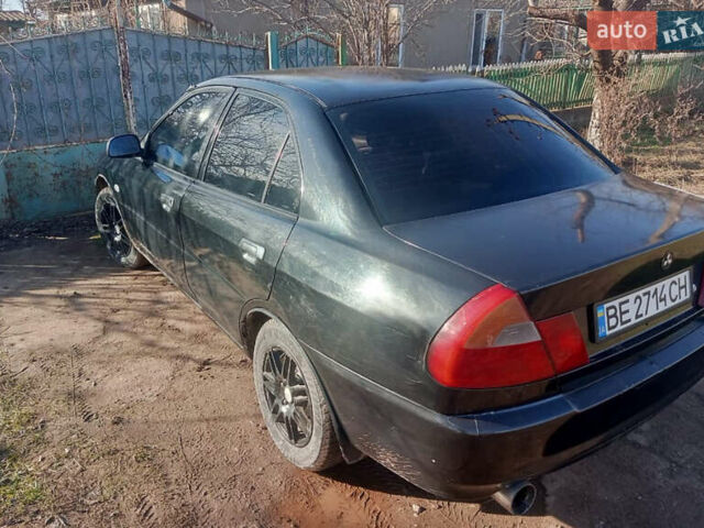 Черный Мицубиси Лансер, объемом двигателя 1.3 л и пробегом 300 тыс. км за 2000 $, фото 4 на Automoto.ua