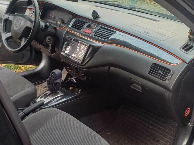 Черный Мицубиси Лансер, объемом двигателя 1.6 л и пробегом 218 тыс. км за 3200 $, фото 4 на Automoto.ua