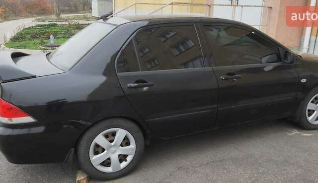 Черный Мицубиси Лансер, объемом двигателя 1.58 л и пробегом 240 тыс. км за 3700 $, фото 12 на Automoto.ua
