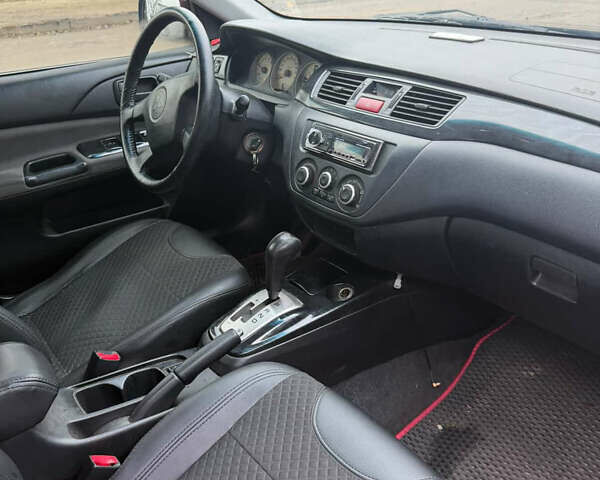 Черный Мицубиси Лансер, объемом двигателя 1.58 л и пробегом 229 тыс. км за 3700 $, фото 5 на Automoto.ua