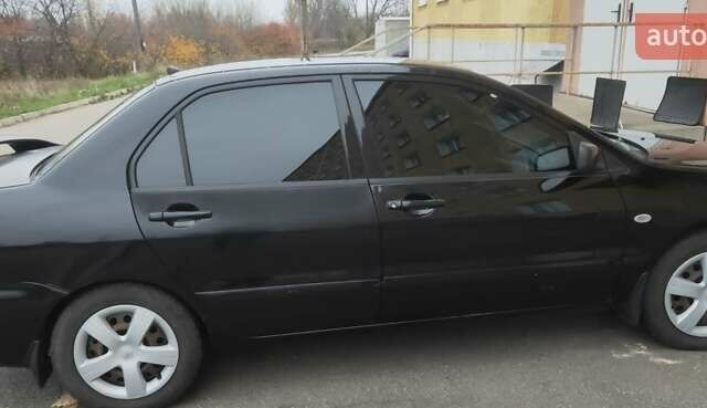 Черный Мицубиси Лансер, объемом двигателя 1.58 л и пробегом 240 тыс. км за 3700 $, фото 2 на Automoto.ua