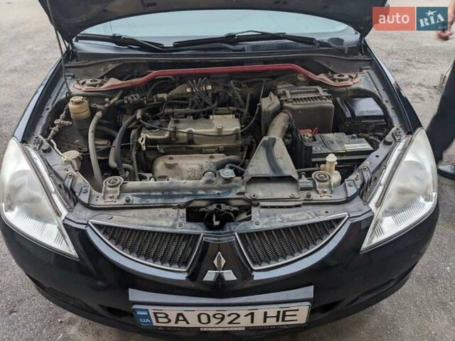 Черный Мицубиси Лансер, объемом двигателя 1.58 л и пробегом 240 тыс. км за 3700 $, фото 7 на Automoto.ua