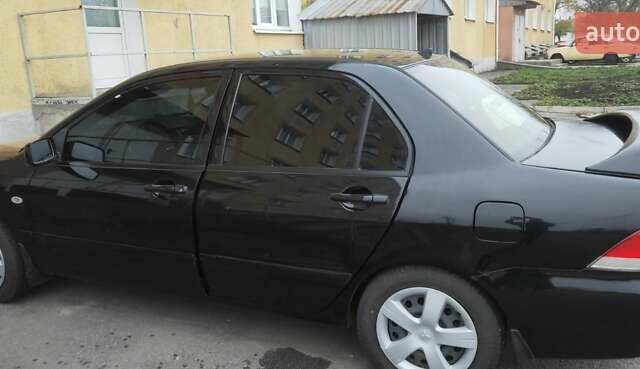 Черный Мицубиси Лансер, объемом двигателя 1.58 л и пробегом 240 тыс. км за 3700 $, фото 9 на Automoto.ua
