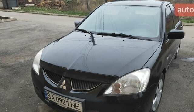 Черный Мицубиси Лансер, объемом двигателя 1.58 л и пробегом 240 тыс. км за 3700 $, фото 1 на Automoto.ua