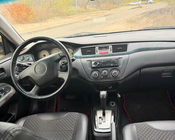 Черный Мицубиси Лансер, объемом двигателя 1.58 л и пробегом 229 тыс. км за 3700 $, фото 6 на Automoto.ua