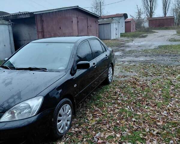 Черный Мицубиси Лансер, объемом двигателя 1.58 л и пробегом 238 тыс. км за 3500 $, фото 7 на Automoto.ua