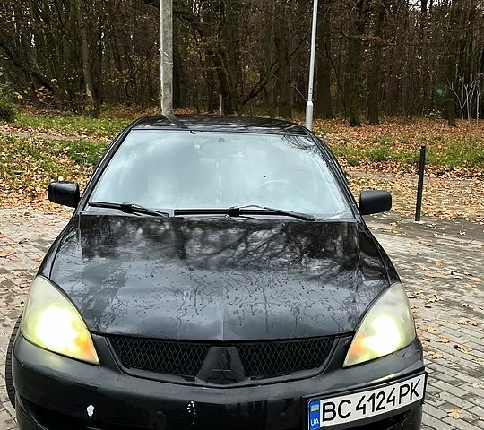 Черный Мицубиси Лансер, объемом двигателя 1.6 л и пробегом 200 тыс. км за 3000 $, фото 1 на Automoto.ua