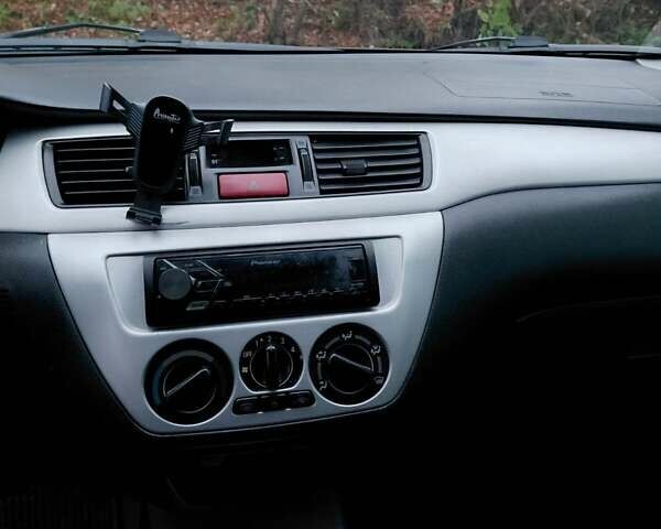 Черный Мицубиси Лансер, объемом двигателя 1.58 л и пробегом 238 тыс. км за 3500 $, фото 1 на Automoto.ua