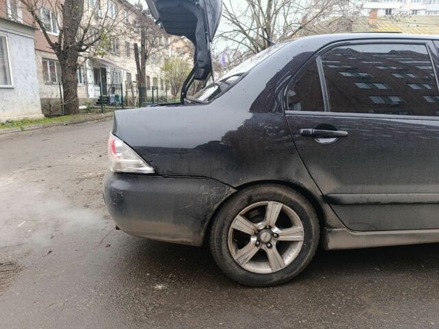 Черный Мицубиси Лансер, объемом двигателя 2 л и пробегом 275 тыс. км за 2599 $, фото 2 на Automoto.ua