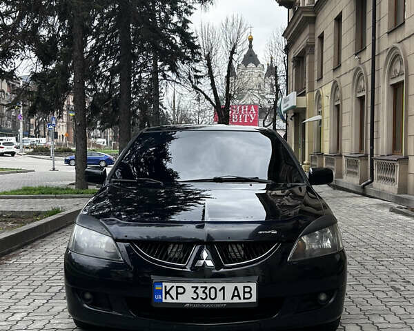 Черный Мицубиси Лансер, объемом двигателя 2 л и пробегом 210 тыс. км за 5300 $, фото 2 на Automoto.ua