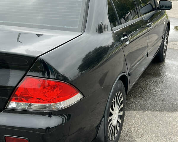 Черный Мицубиси Лансер, объемом двигателя 1.58 л и пробегом 300 тыс. км за 3850 $, фото 10 на Automoto.ua