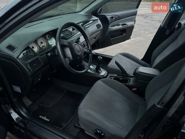 Черный Мицубиси Лансер, объемом двигателя 1.58 л и пробегом 154 тыс. км за 5500 $, фото 26 на Automoto.ua