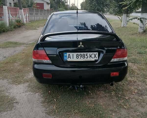 Чорний Міцубісі Lancer, об'ємом двигуна 1.58 л та пробігом 210 тис. км за 2999 $, фото 5 на Automoto.ua
