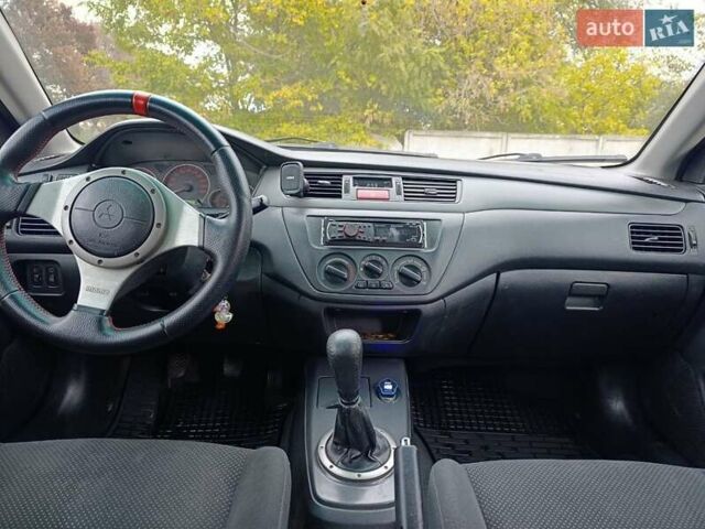 Черный Мицубиси Лансер, объемом двигателя 2 л и пробегом 225 тыс. км за 4400 $, фото 13 на Automoto.ua