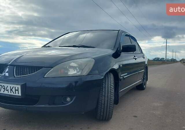 Черный Мицубиси Лансер, объемом двигателя 2 л и пробегом 225 тыс. км за 4400 $, фото 2 на Automoto.ua