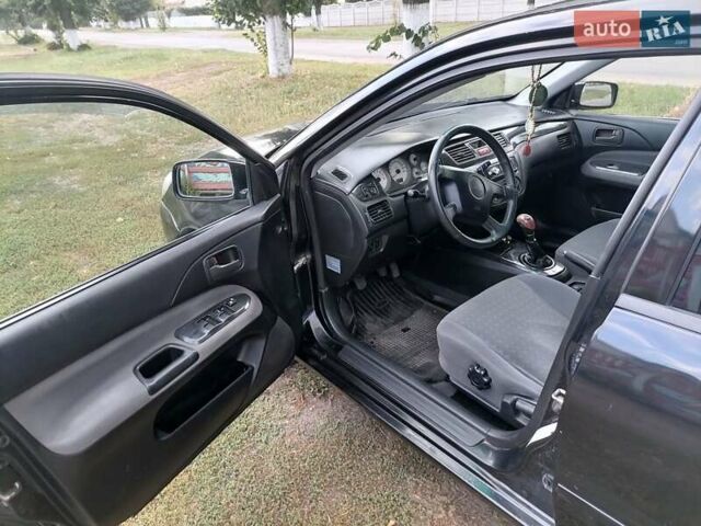Чорний Міцубісі Lancer, об'ємом двигуна 1.58 л та пробігом 210 тис. км за 2999 $, фото 9 на Automoto.ua