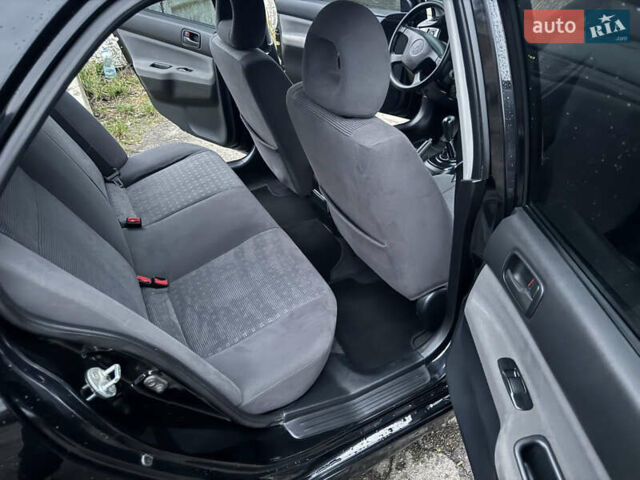 Черный Мицубиси Лансер, объемом двигателя 1.58 л и пробегом 154 тыс. км за 5500 $, фото 33 на Automoto.ua