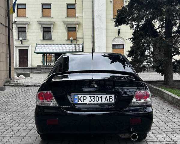 Черный Мицубиси Лансер, объемом двигателя 2 л и пробегом 210 тыс. км за 5300 $, фото 7 на Automoto.ua