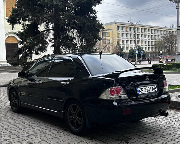 Черный Мицубиси Лансер, объемом двигателя 2 л и пробегом 210 тыс. км за 5300 $, фото 9 на Automoto.ua