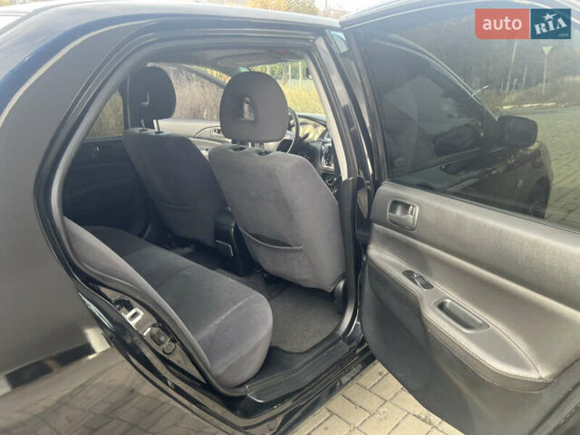 Чорний Міцубісі Lancer, об'ємом двигуна 1.58 л та пробігом 364 тис. км за 4000 $, фото 11 на Automoto.ua