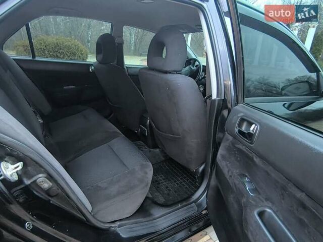 Чорний Міцубісі Lancer, об'ємом двигуна 1.58 л та пробігом 263 тис. км за 4500 $, фото 12 на Automoto.ua
