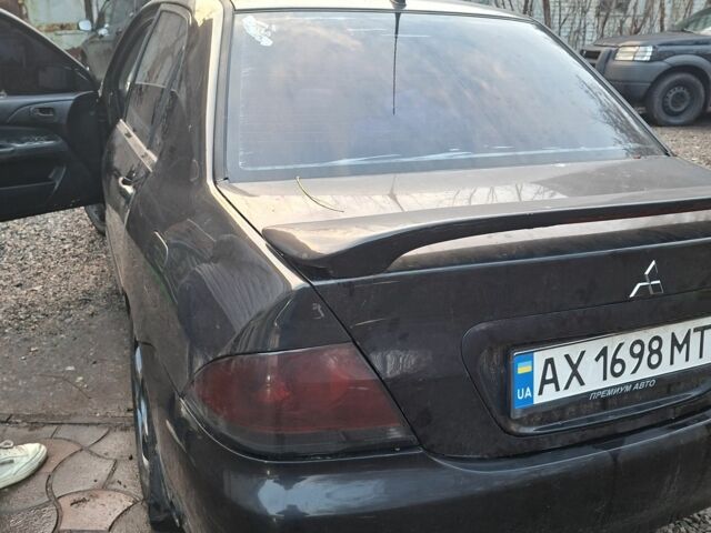 Чорний Міцубісі Lancer, об'ємом двигуна 1.6 л та пробігом 290 тис. км за 3800 $, фото 1 на Automoto.ua