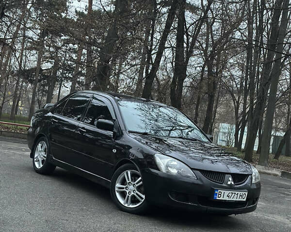 Черный Мицубиси Лансер, объемом двигателя 2 л и пробегом 250 тыс. км за 3700 $, фото 4 на Automoto.ua