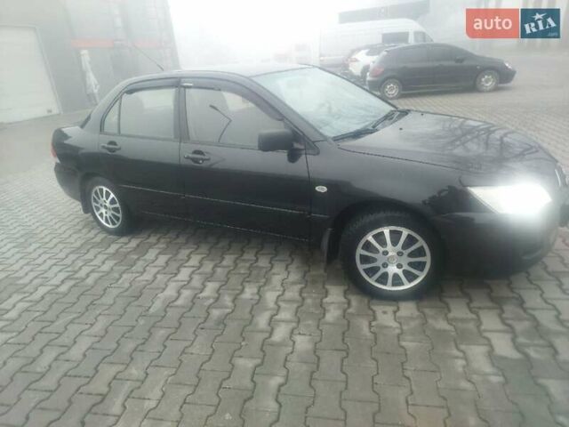 Чорний Міцубісі Lancer, об'ємом двигуна 1.58 л та пробігом 275 тис. км за 3100 $, фото 9 на Automoto.ua