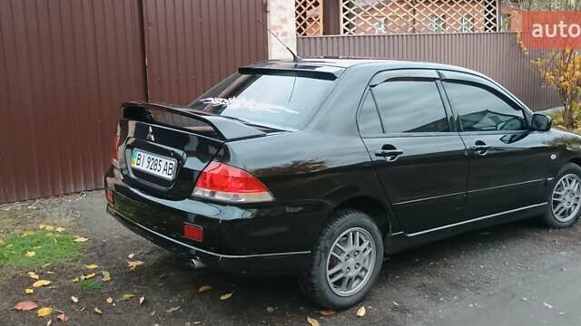 Черный Мицубиси Лансер, объемом двигателя 1.58 л и пробегом 261 тыс. км за 4400 $, фото 7 на Automoto.ua