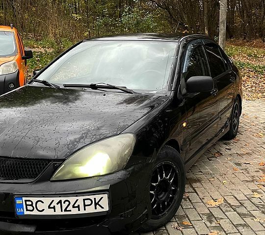 Черный Мицубиси Лансер, объемом двигателя 1.6 л и пробегом 200 тыс. км за 3000 $, фото 2 на Automoto.ua