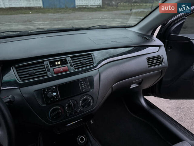 Черный Мицубиси Лансер, объемом двигателя 1.58 л и пробегом 154 тыс. км за 5500 $, фото 30 на Automoto.ua