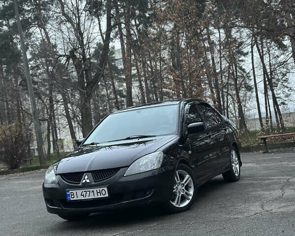 Черный Мицубиси Лансер, объемом двигателя 2 л и пробегом 250 тыс. км за 3700 $, фото 1 на Automoto.ua